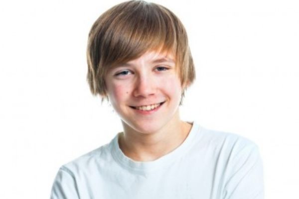 Boy smiling in front of white background