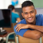 Student in classroom crossing arms and smiling