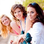 Group of three girls smiling outside