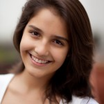 Girl smiling in front of a blurred background