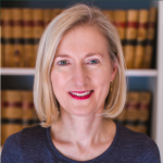 Dr. Catherine Zip headshot in front of book shelf